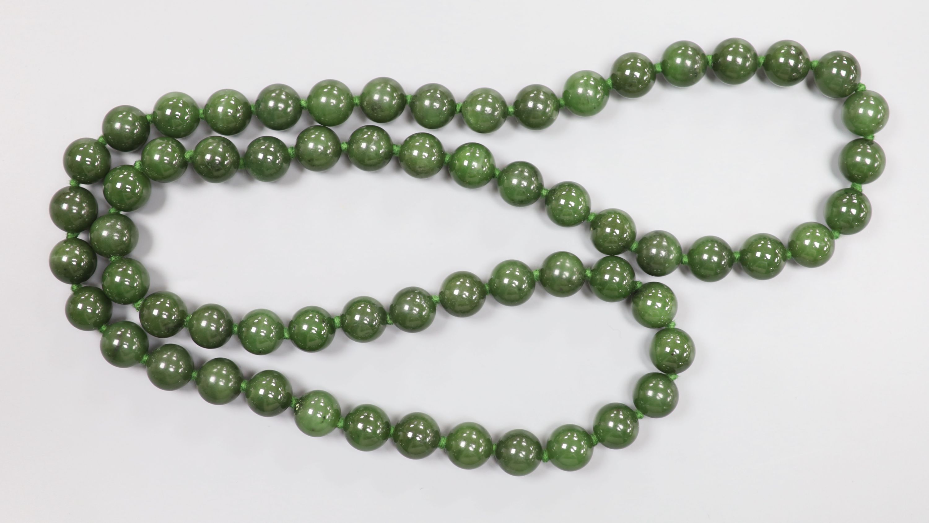 A single strand nephrite circular bead necklace, 82cm, gross weight 171 grams,
